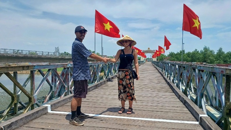 A split visual showing a group tour bus and a private car with a guide traveling through historic DMZ sites near Hue, Vietnam, representing different pricing options for DMZ tours.