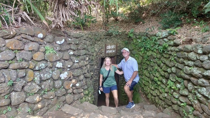 A comparison scene showing a private car with a guide versus a group bus tour exploring historic DMZ sites near Hue, Vietnam, highlighting different travel styles and comfort levels.